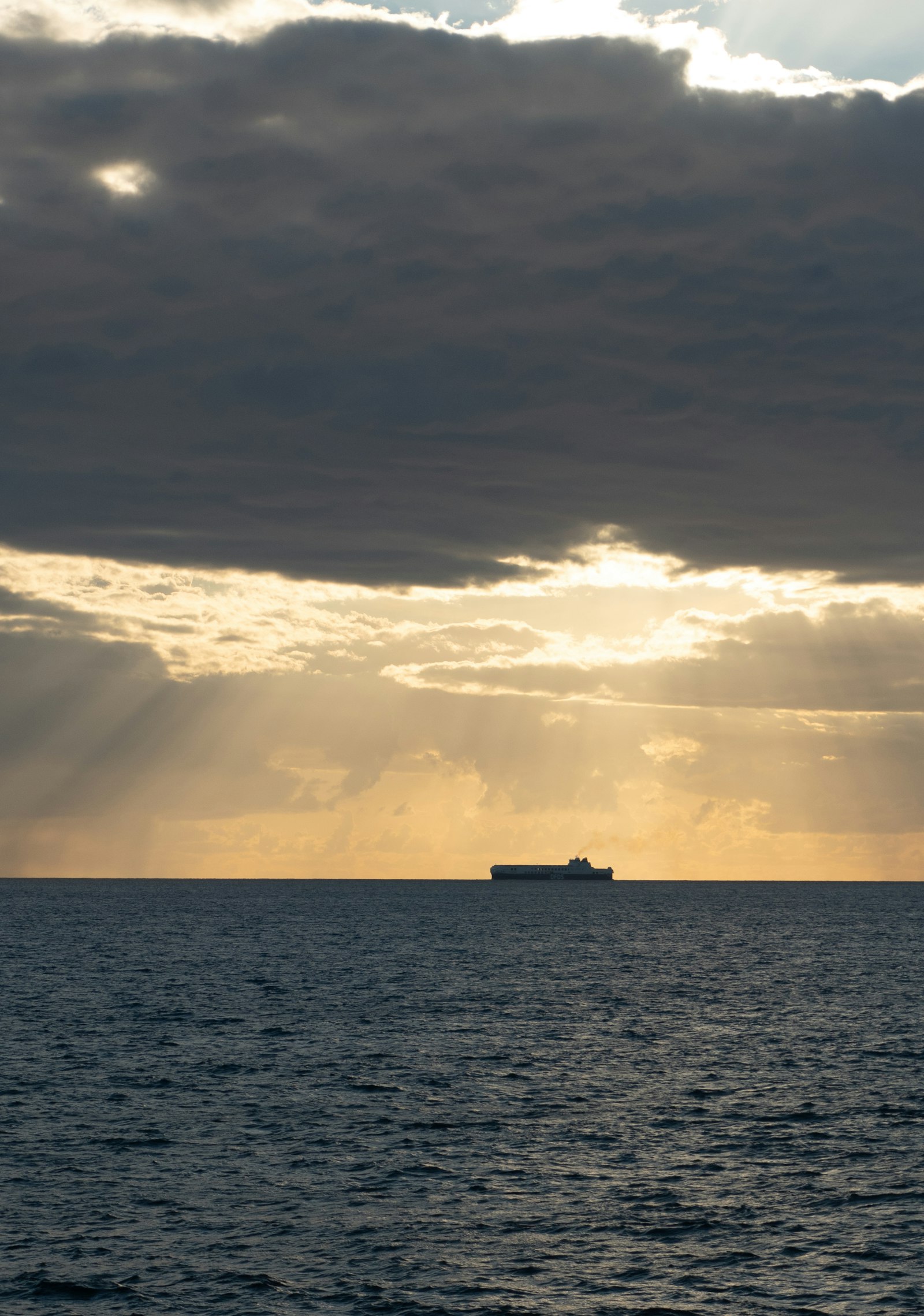 Cargo ship under dramatic clouds